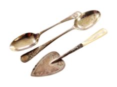Two silver teaspoons and a silver trowel with mother of pearl handle.