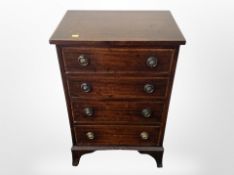 A mahogany and satin wood inlaid four drawer low chest,