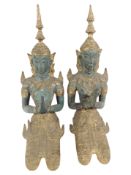 A pair of Thai gilt and patinated metal figures of seated Buddhas, height 33cm.