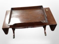A reproduction mahogany drop leaf coffee table and an oak tray