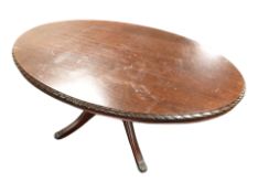 A reproduction mahogany oval coffee table,