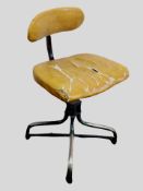 A 20th century Tan-sad metal and tan vinyl swivel chair