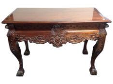 A Victorian style carved hardwood console table on claw and ball feet,