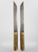 A pair of amateur forged pang-style knives with brass handles, length 26.5cm.