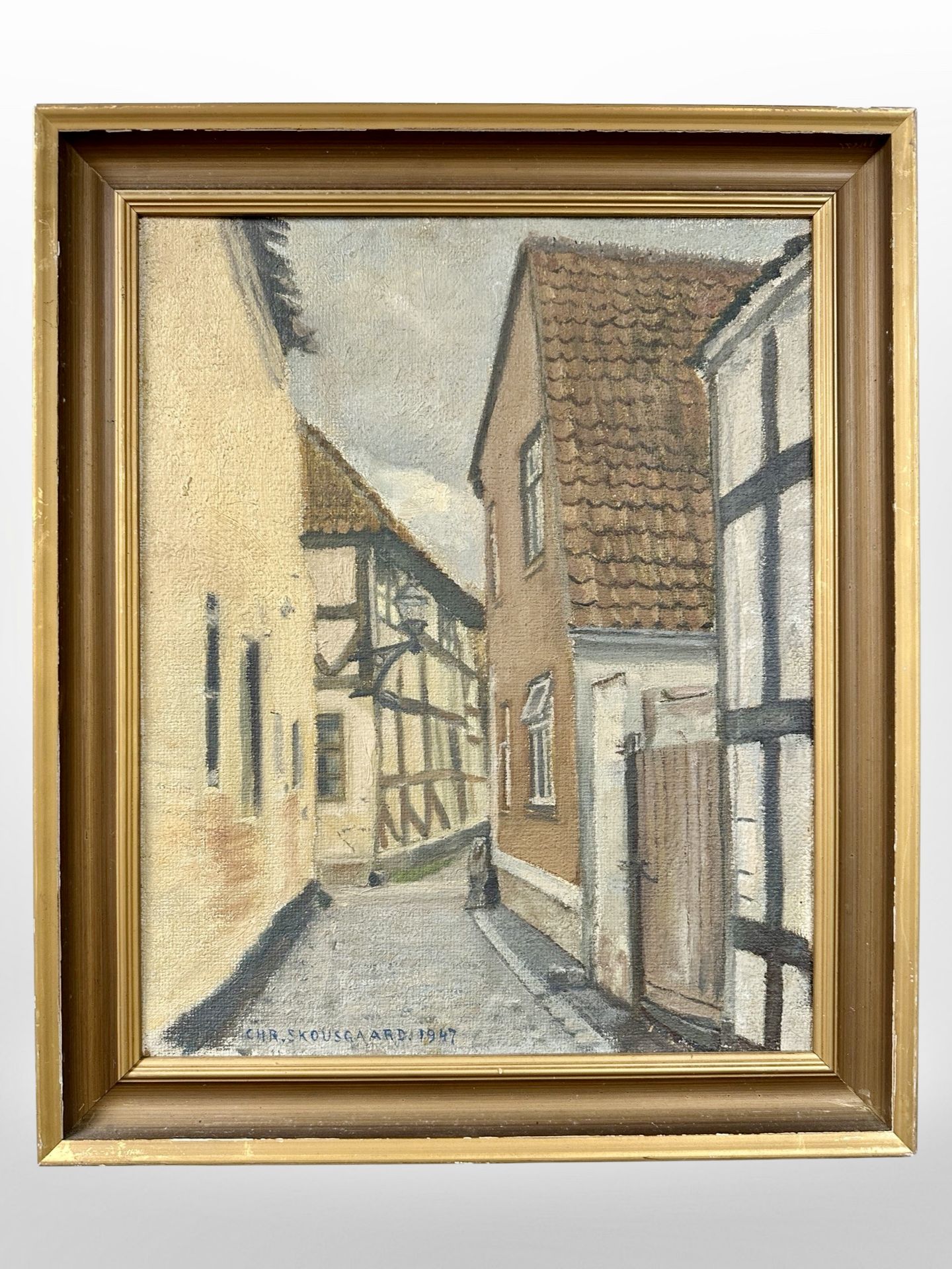 C Skousgaard : A cobbled street through a town, oil on canvas, 32cm x 39cm.