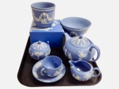 Seven pieces of Wedgwood blue Jasperware including pedestal bowl, boxed urn, teapots.