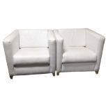 A pair of white stitched leather armchairs,