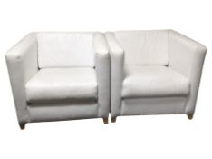 A pair of white stitched leather armchairs,