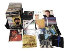 A box of LP records, including Dire Straits, The Beatles, Blondie, The Human League,