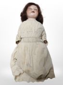 An Armand Marseille poreclain-headed doll stamped 'A.975 M Germany 5'.