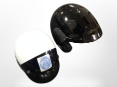 A motorbike helmet marked 'Hawaii County Police', together with a Nolan motorcycle helmet type A.
