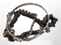 A Links of London black and gold tone bracelet, a silver bracelet, and a bangle.