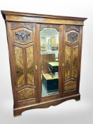 A Victorian carved walnut triple door wardrobe,