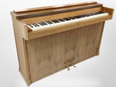 A Hornung & Møller burr walnut-cased overstrung upright piano, 134cm x 42cm x 89cm.