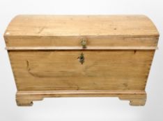 A 19th century pine dome topped trunk with cast iron handles,