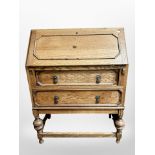 An Edwardian oak writing bureau,