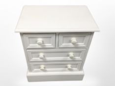 A contemporary white painted four drawer low chest,