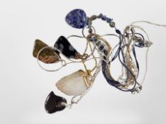 Five assorted pendants set with semi-precious stones.