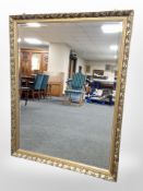 A gilt-framed bevelled overmantle mirror, 114cm x 87cm.