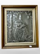 An Arts and Crafts embossed pewter panel depicting two owls perched on a branch, 33cm x 28cm.