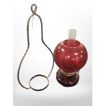 A ruby glass hanging oil lamp.