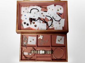 A contemporary jewellery box containing engraved silver bangle, numerous pair of earrings,