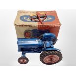 A Chad Valley working scale model of the New Fordson Major tractor, in original box with a plow.