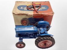 A Chad Valley working scale model of the New Fordson Major tractor, in original box with a plow.