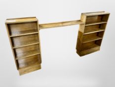 An Edwardian oak two part open bookcase, with central adjoining shelf,