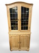A Danish blonde oak glazed double-door cabinet, 87cm x 48cm x 175cm.