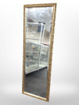 A contemporary gilded rectangular mirror, 127cm x 43cm.