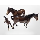 Two Beswick brown-gloss horses and a further foal, tallest 13.5cm.