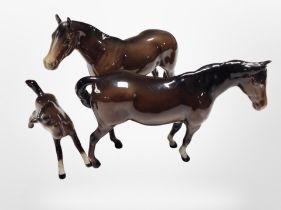 Two Beswick brown-gloss horses and a further foal, tallest 13.5cm.
