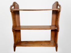 A Victorian carved walnut three tier wall shelf,