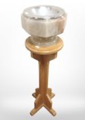 An onyx church font on oak stand, overal 95cm high.
