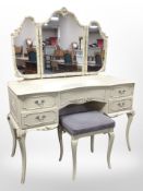A French style cream and gilt dressing table with matching stool,