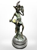 A patinated bronze figure of an elf seated on a tree stump, in the manner of David Goode,