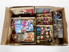 A box of Christmas tree baubles and other decorations.