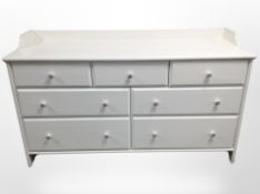 A contemporary painted seven drawer chest,