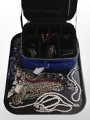 A contemporary jewellery case and contents to include faux pearls, bead necklaces, etc.