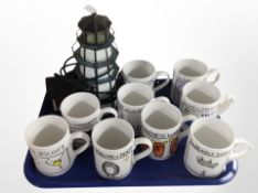 A glass table lamp in the form of a lighthouse together with nine McLaggan Smith mugs designed by