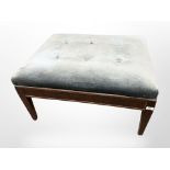 An early 20th-century mahogany-framed rectangular foot stool in blue dralon upholstery, length 80cm.