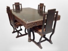 An Oriental heavily carved and ebonised dining table, length 176 cm,