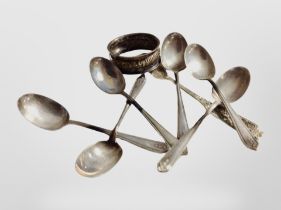 A set of six silver teaspoons, a further continental silver spoon, and a napkin ring.