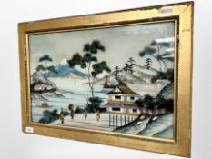 A Japanese print on glass depicting figures in a landscape, 59cm x 38cm.