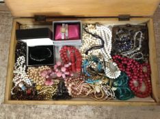 A wooden box of costume bead necklaces, ladies' wristwatch, beadwork purse, etc.