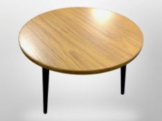 A Herman Miller teak effect circular low occasional table on tapered legs, diameter 57cm,