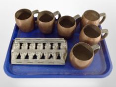 A chocolate mould together with six Flemish copper tankards