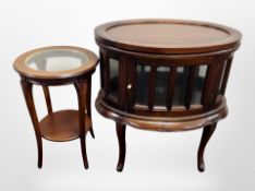 A reproduction mahogany glazed oval cabinet,