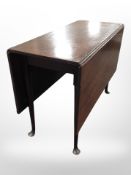 A 19th century mahogany drop leaf dining table on pad feet,
